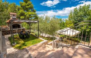 an outdoor patio with a table and a grill at Apartments in Soline - Insel Krk 41809 in Soline