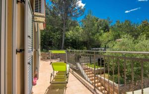 a balcony with two chairs and a table at Apartments in Soline - Insel Krk 41809 in Soline