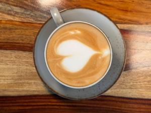 a cup of coffee with a spoon in it at Villa Himalayan Trove in Jāmb