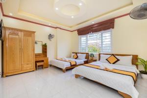 a bedroom with two beds and a desk at Hoàng My Villa - 100m tới bãi tắm Long Cung in Vung Tau +43 photos