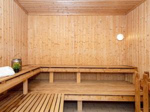 a wooden sauna with a bench in a room at 4 person holiday home in Ringkøbing in Ringkøbing