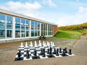 a chess board on the ground in front of a building at 4 person holiday home in Ringkøbing in Ringkøbing
