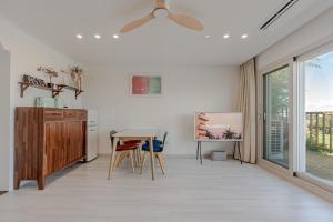 a kitchen with a ceiling fan and a table and chairs at Jeju Stayra in Sowang-dong +27 photos