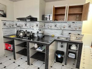 a kitchen with a counter and a sink at Hotel Cordillera Blanca in Caraz