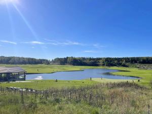 a view of a golf course with a lake at Akersberga Apartment close to Sea in Åkersberga