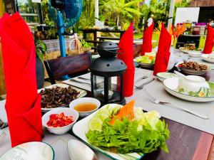 a table with plates of food and bowls of salad at Vvillage  +64 photos