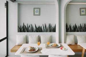 a dining room with two plates of food on a table at Go2bed Pattaya Hotel in Pattaya