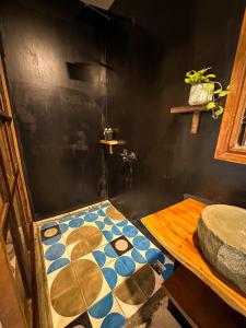 a room with a shower with a table in it at Gallery House - Artistic Villa with Plunge Pool in Phumĭ Réach Born (1) +41 photos