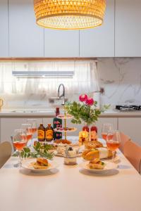 a table with plates of food and glasses of wine at 온유재스테이 N seoul tower 800m in Seoul