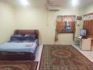 Ένα ή περισσότερα κρεβάτια σε δωμάτιο στο Teratak Desa Cemerlang 3