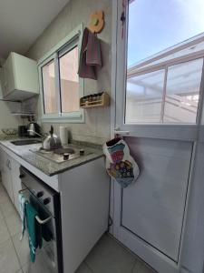 una piccola cucina con un lavandino e una finestra di Excelente departamento con 2 patios en Zona Aldrey a Mar del Plata