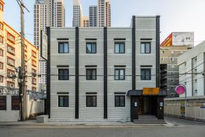 a building in a city with tall buildings at Mitasuya Ryokan Hotel Daejeon Yongjeon in Daejeon