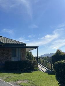 a house with a porch and a view of the mountains at Hillview Studio One in Berry