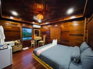 a bedroom with a bed in a room with wooden walls at Vvillage 