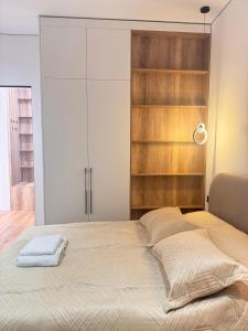 a bed with two towels on it in a room at Аппартамент в Астане in Astana