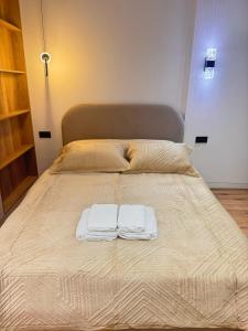 a bed with two towels on top of it at Аппартамент в Астане in Astana