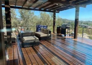 a deck with a couch and chairs and a table at Casa Brisa in Chivato