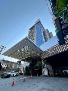 a parking lot with orange cones in front of a building at The Cabin Apartment Uttara in Yogyakarta