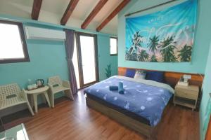 a bedroom with a bed with a painting on the wall at Penghu's peace in Magong
