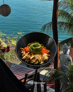 a pan of food on top of a table at Casa China Guesthouse & Hostal in Bacalar +10 photos