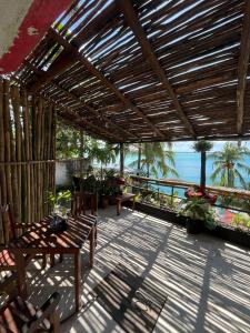 a patio with a table and a view of the ocean at Casa China Guesthouse & Hostal in Bacalar