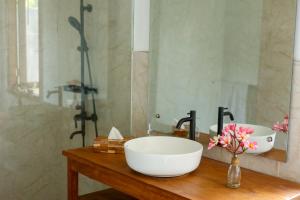 a bathroom with a sink and a mirror at Bobocha Tangkoko Nature Resort in Bitung +36 photos