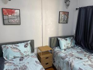 a bedroom with a bed and a night stand next to a bed at Ban Pak Khun Taa in Khon Kaen