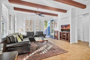 a living room with a couch and a table at LV305 Legacy Villas Townhome w Expansive Patio in La Quinta