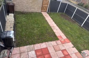 une cour avec une clôture et un jardin avec du gazon dans l'établissement Ama comfort Stay, à Hythe