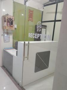 a room with a white counter with a sign on it at hotel shreejee in Himatnagar