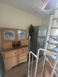 a room with a wooden dresser and a ladder at Ferienwohnung Weber in Bergen