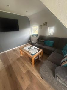 a living room with a couch and a coffee table at Ferienwohnung Weber in Bergen