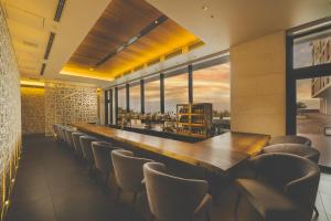 a bar with a long table and chairs at Hyatt Regency Seragaki Island Okinawa in Onna +142 photos