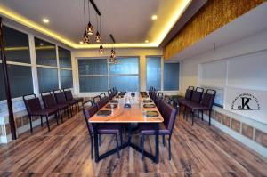 a dining room with a long table and chairs at Royal Serene Villas in Ooty