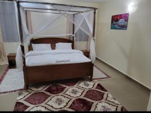 Ένα ή περισσότερα κρεβάτια σε δωμάτιο στο Diani Airport View Apartments