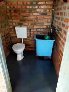 a bathroom with a toilet and a bath tub at Rock Village in Jeniang