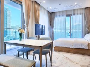 a hotel room with a bed and a table and chairs at Paramion Hotel in Busan