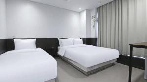 Ένα ή περισσότερα κρεβάτια σε δωμάτιο στο Jongno The Stay Korea +6 φωτογραφίες