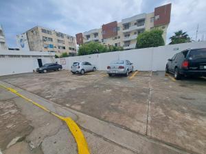 three cars parked in a parking lot next to a building at Hotel Playamar in Mazatlán +1 photo