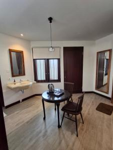 a room with a sink and a table and a sink at The Castle Medan Penginapan Syariah in Medan