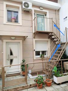 a house with a spiral staircase in front of it at To Bee or not to Bee! in Volos