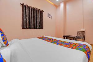 a bedroom with a bed with a colorful blanket on it at Via The Heaven in Pune