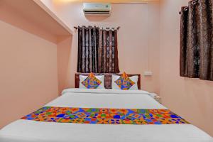 a bedroom with a large bed with colorful pillows at Via The Heaven in Pune