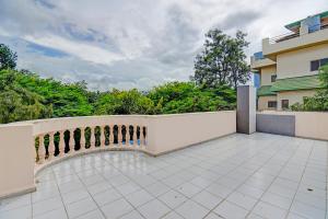 a patio with a white fence and trees at Via The Heaven in Pune