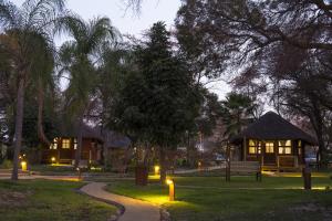 un cenador con luces en un parque por la noche en Gondwana Hakusembe River Lodge en Rundu