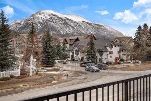 a view of a town with a snow covered mountain at Stunning Modern 2BR Unit in Downtown Canmore in Canmore