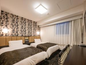 Ένα ή περισσότερα κρεβάτια σε δωμάτιο στο APA Hotel Nagoya Ekimae Kita