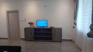 a television sitting on a cabinet in a room at Willowbrook in Aburi