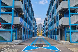a hallway between two tall buildings with a star on the ground at Runway 1331 -ENLIGHT Youth Hostel in Hong Kong +58 photos