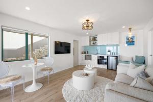 a living room with a couch and a table at Wanaka Studio - sea views from your private patio in New Plymouth